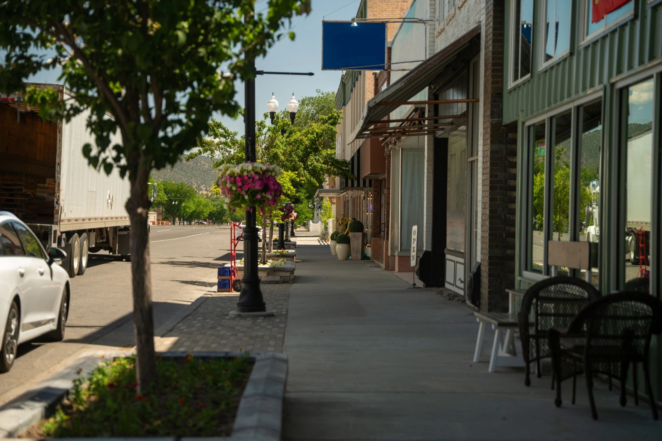 Small-town downtown streetscape with storefronts and planters